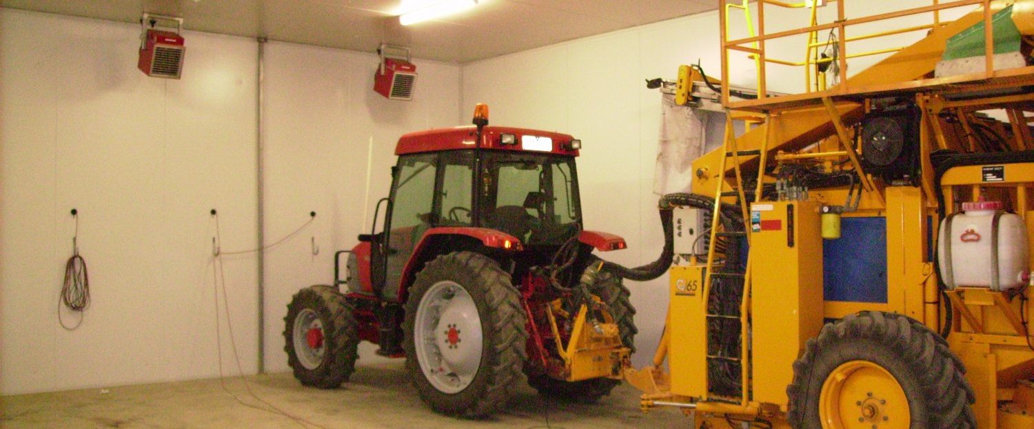tractor and other harvesting machinery in a shed