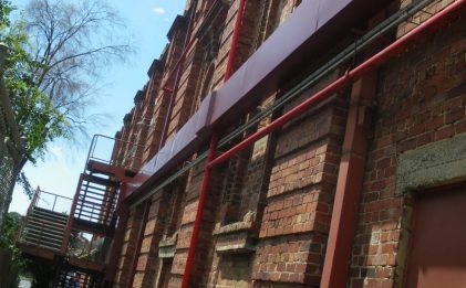 an outside side view of a red brick building