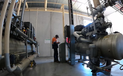 man wearing high vis performing maintenance works at an industrial refrigeration plant