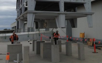 three men wearing hi vis and hard hats on a construction site